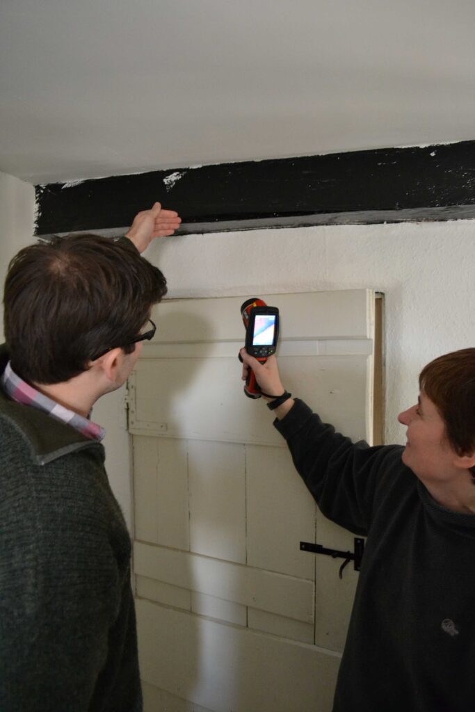 Home Energy Doctor examining building with client